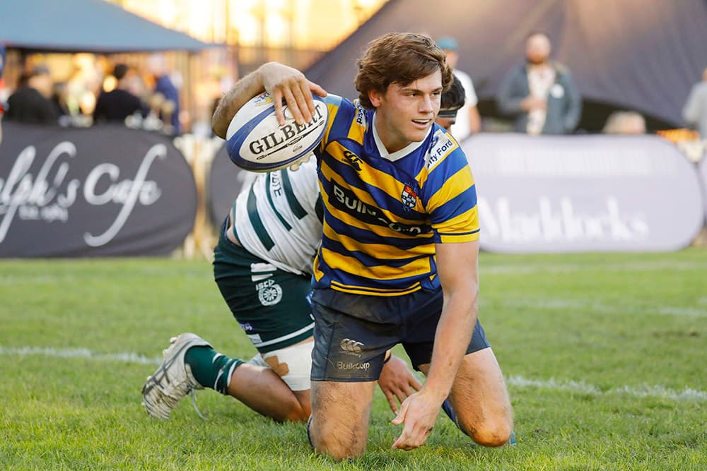 Henry Robertson celebrates a try for the Students yesterday. Photo: Karen Watson
