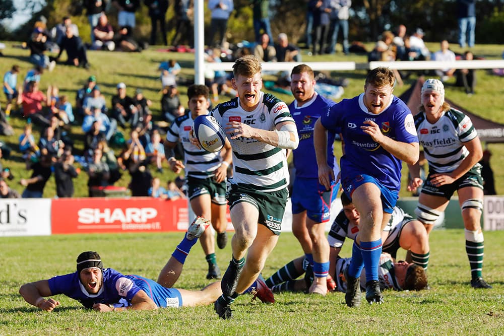 Harry Anderson-Brown charges away from the Manly defenders. Photo: Karen Watson